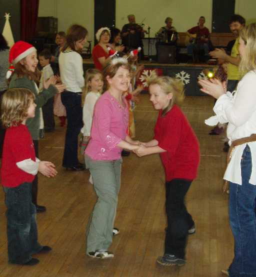 Children dancing at Comann 
                      nam P�rant Christmas Party
